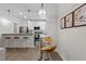 Open concept kitchen with stainless steel appliances, breakfast bar, and modern pendant lighting at 1300 Broad St # A, Durham, NC 27705