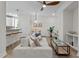 Stylish living area with a ceiling fan, plush sofa, and a view to the kitchen bar with stool seating at 1300 Broad St # A, Durham, NC 27705