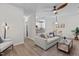 Bright living room featuring modern ceiling fan, wood floors, and seamless flow into the kitchen at 1300 Broad St # A, Durham, NC 27705