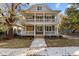 Two-story house with gray siding, white trim, and a wraparound porch at 1300 Broad St # C, Durham, NC 27705