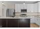 Modern kitchen with white cabinets, granite countertops, and stainless steel appliances at 1300 Broad St # C, Durham, NC 27705