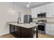 Modern kitchen with white cabinets, granite countertops and island at 1300 Broad St # C, Durham, NC 27705
