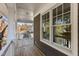 Spacious porch with wooden flooring and white railings, offering views of the neighborhood at 1300 Broad St # C, Durham, NC 27705