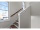 Elegant wooden staircase with white railings and large windows at 1300 Broad St # C, Durham, NC 27705