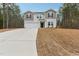 Two-story house with gray and white siding, a two-car garage, and a neatly landscaped yard at 142 Teagarden Ct, Sanford, NC 27332