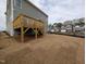 Backyard featuring a wooden deck, lawn, and gray siding of the house and other nearby homes at 19 Grassland Dr, Garner, NC 27529