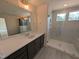 Bathroom boasts a vanity, a large mirror, and a glass enclosed shower featuring built-in seat at 19 Grassland Dr, Garner, NC 27529
