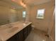 Bright bathroom featuring double sinks, vanity, and a tub/shower perfect for everyday convenience at 19 Grassland Dr, Garner, NC 27529