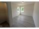 Bright bedroom with wood-look flooring, two windows, and a spacious closet for ample storage at 19 Grassland Dr, Garner, NC 27529