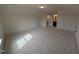 Large carpeted bonus room with two entry doors is bright with natural light at 19 Grassland Dr, Garner, NC 27529
