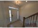 Bright entryway featuring hardwood floors, elegant trim, and a beautiful staircase at 19 Grassland Dr, Garner, NC 27529