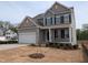 Charming two-story home with a two-car garage, front porch, and landscaped yard at 19 Grassland Dr, Garner, NC 27529