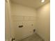 Functional laundry room with hookups, shelving and wood-look floors at 19 Grassland Dr, Garner, NC 27529