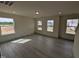 Inviting living room with abundant natural light, and wood-look floors perfect for relaxing or entertaining at 19 Grassland Dr, Garner, NC 27529