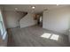 Spacious living area with wood-look flooring and open floor plan, ideal for modern living and entertaining at 19 Grassland Dr, Garner, NC 27529
