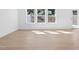 Spacious living room with hardwood floors and large windows at 2000 Regal Dr # 88, Durham, NC 27703