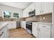 Modern kitchen with white cabinets, stainless steel appliances, and a tile backsplash at 2006 Regal Dr # 85, Durham, NC 27703