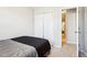 Small bedroom with gray bedding and access to a hallway at 207 Hampshire Downs Dr, Morrisville, NC 27560