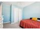 Cozy bedroom with orange bedding and double door closet at 207 Hampshire Downs Dr, Morrisville, NC 27560