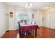 Bright dining room features hardwood floors and a charming table setting at 207 Hampshire Downs Dr, Morrisville, NC 27560