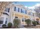 Two-story townhome with gray and beige siding, covered porch at 207 Hampshire Downs Dr, Morrisville, NC 27560