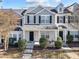 Two-story townhome with a covered porch and well-manicured landscaping at 207 Hampshire Downs Dr, Morrisville, NC 27560