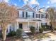Two-story townhome with a covered porch and landscaped front yard at 207 Hampshire Downs Dr, Morrisville, NC 27560