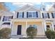 Two-story townhome, beige and gray siding, covered porch at 207 Hampshire Downs Dr, Morrisville, NC 27560