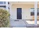Covered front porch with two wooden chairs and a black door at 207 Hampshire Downs Dr, Morrisville, NC 27560
