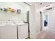 White washer and dryer in laundry room with extra shelving at 207 Hampshire Downs Dr, Morrisville, NC 27560