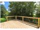 Wooden deck with a view of a lush green backyard at 2112 Stanchion St, Haw River, NC 27258