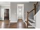 Elegant staircase with dark wood railings and hardwood floors at 2112 Stanchion St, Haw River, NC 27258