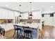 Stylish kitchen featuring white cabinetry, brick backsplash, stainless steel appliances, and a center island with seating at 213 Quarter Gate Trace, Chapel Hill, NC 27516