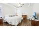 Bright bedroom featuring hardwood floors, crown molding, and a comfortable bed with decorative pillows at 213 Quarter Gate Trace, Chapel Hill, NC 27516