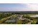 Aerial view of tennis courts and a pond at 213 Quarter Gate Trace, Chapel Hill, NC 27516