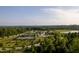 Aerial view of tennis courts and a pond at 213 Quarter Gate Trace, Chapel Hill, NC 27516