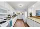 Kitchen with white cabinets, granite countertops, and tile floor at 2301 Euston St, Raleigh, NC 27610