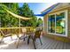 Deck with shaded seating area and glass table at , Raleigh, NC 27604