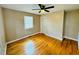 Well-lit bedroom, hardwood floors, and ceiling fan at 2923 Mckinney St, Burlington, NC 27217