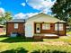 Back of house, showcasing the patio and additional yard space at 2923 Mckinney St, Burlington, NC 27217