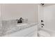 Clean bathroom with single vanity, granite countertop, and shower/tub at 305 E Pope Ave, Kenly, NC 27542