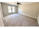 Large bedroom with plush carpeting and a window at 305 E Pope Ave, Kenly, NC 27542