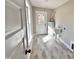 Laundry room with utility sink and built-in shelving at 305 E Pope Ave, Kenly, NC 27542