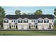 Three-story townhome building with attached garages and lawn at 313 Cherry Laurel Dr, Sanford, NC 27332