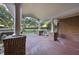 Brick front porch with columns and a white metal bench at 3701 Baron Cooper Pass # 205, Raleigh, NC 27612