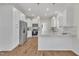 Modern kitchen with white cabinets, granite countertops, and stainless steel appliances at 407 Sixth St, Wake Forest, NC 27587