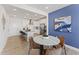 Kitchen and dining area with marble table, modern chairs, and blue accent wall at 410 Gaston Park Ln # 100, Wake Forest, NC 27587