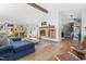 Bright living room with hardwood floors, sectional sofa, and modern fireplace at 4105 Glen Laurel Dr, Raleigh, NC 27612