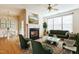 Bright living room with fireplace and green velvet sofa at 4108 Cherry Blossom Cir, Durham, NC 27713