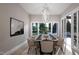 Elegant dining room with large windows and modern chandelier at 4112 Rockingham Dr, Raleigh, NC 27609